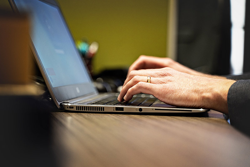 hands close up typing on a laptop