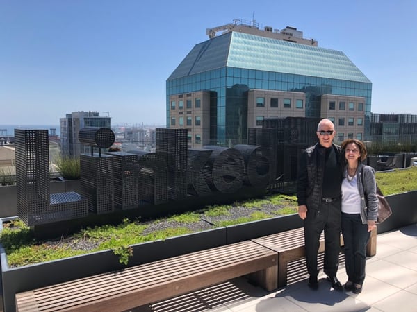 Tony caldwell and his wife Sharon stand in front of a large building