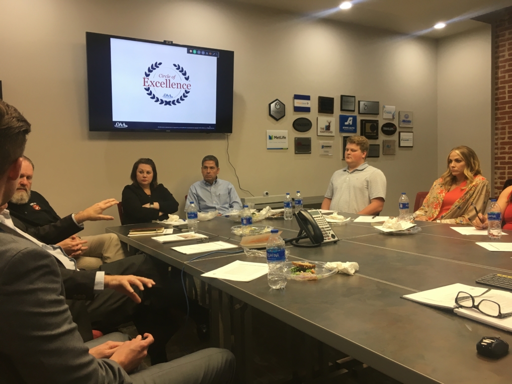 team meeting around a black table