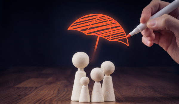 four toy people with umbrella drawn overtop